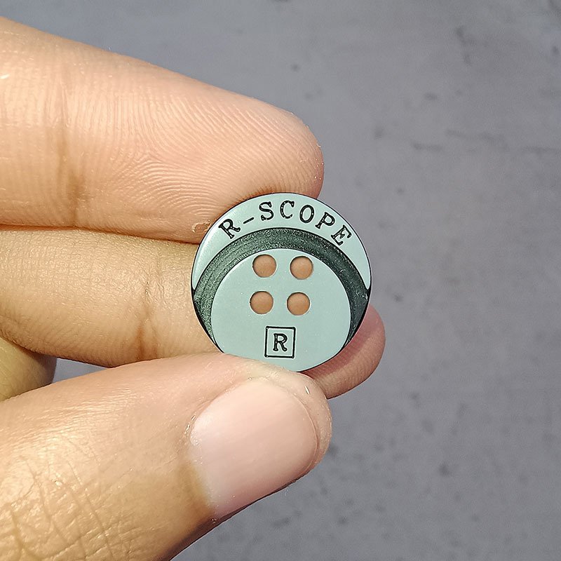 Laser engraved branding in buttons