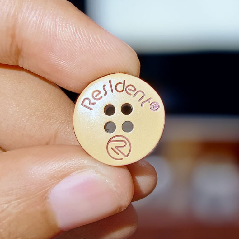 Laser engraved branding in buttons